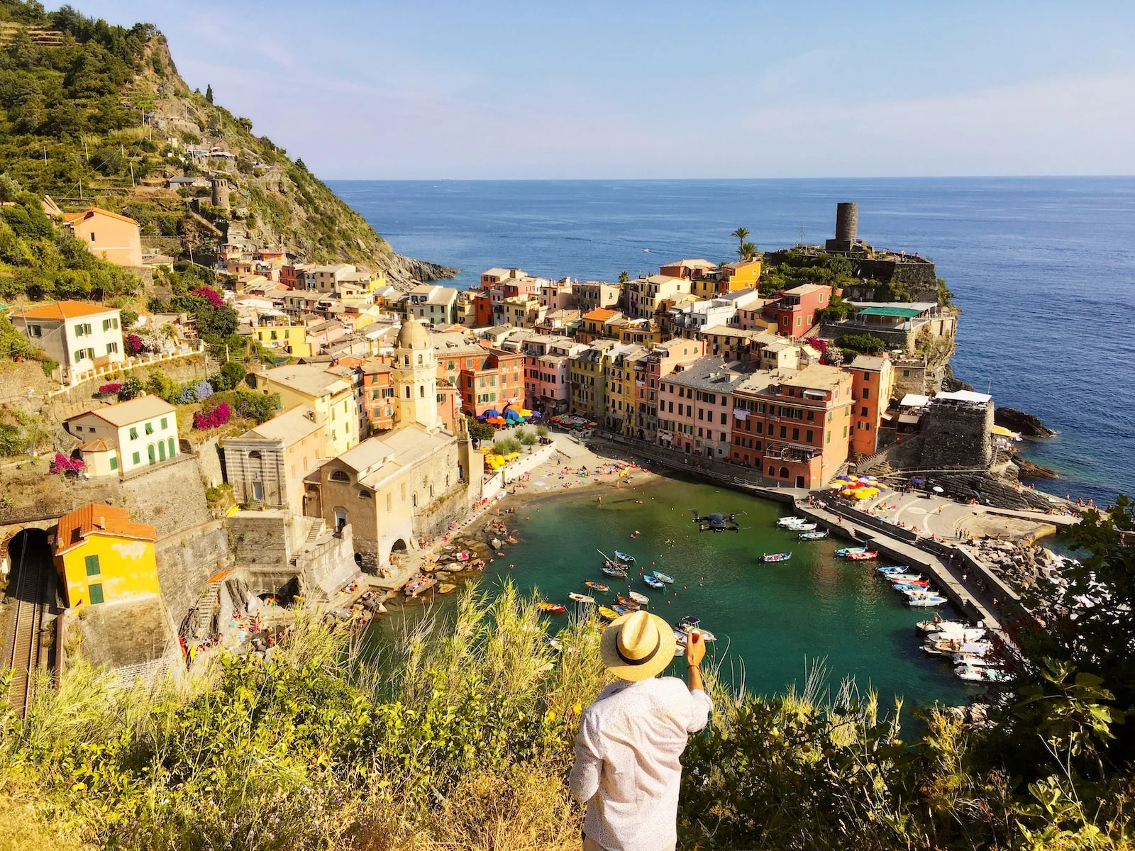 Italie man in white shirt standing on top of a building near the river during daytime