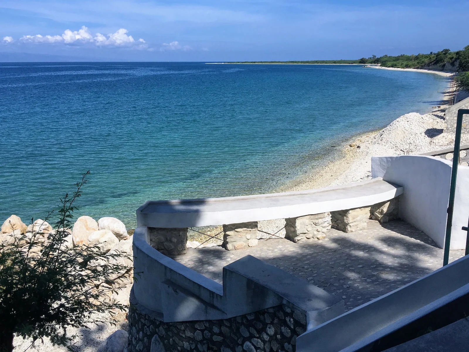 Sainte-Lucie white concrete bench near blue sea under blue sky during daytime
